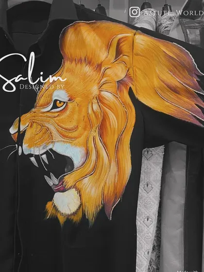 A close-up of a hand-painted roaring lion on a black shirt. The detail and color blending showcase the high level of artistry I bring to my custom pieces.