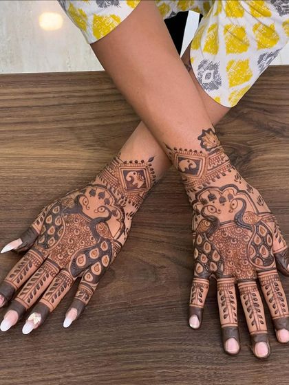 A clear, top-down view of the peacock design, showing the fine details in the feathers and the surrounding patterns.