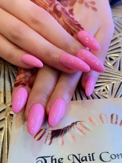 A lovely set of long, almond-shaped nails in a bright, bubblegum pink. This cheerful color is perfect for adding a pop of fun to your look.