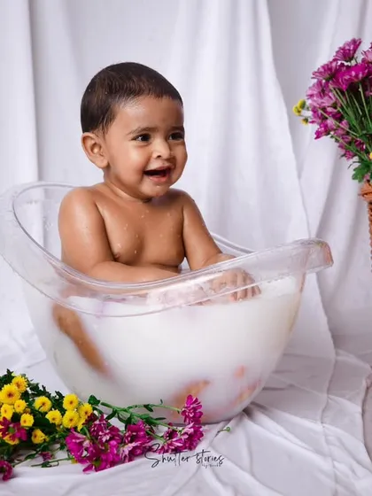 A huge smile from the baby in the tub, clearly loving her splash session.