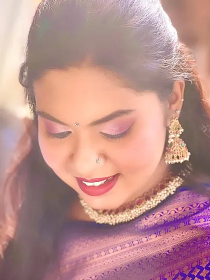 A beautiful candid shot of my client. The soft lighting highlights the shimmer in her eyeshadow and the rich color of her lipstick, creating a dreamy and romantic portrait.