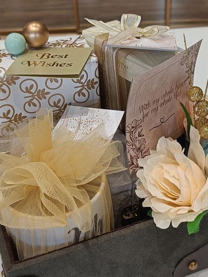 The full engagement hamper for him, assembled in a rustic trunk-style box with flowers, a personalized mug, and other thoughtful presents.
