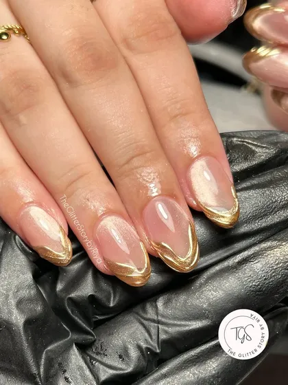A close-up shot of the abstract gold chrome French tips, showcasing the clean lines and high-shine finish.