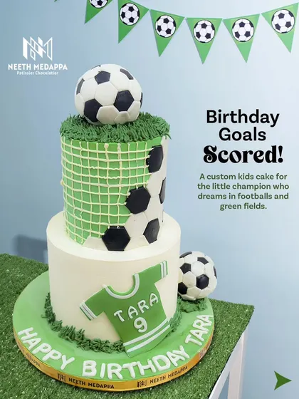 Birthday goals scored for Tara's big day. This custom football-themed cake features a two-tier design with a soccer ball, edible net texture, and a personalized jersey to celebrate her love for the game.
