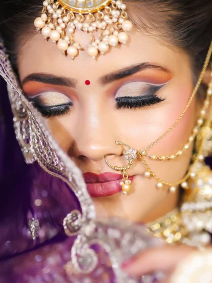 An artistic shot of the bride's eye makeup, featuring a beautiful cut crease with white and silver glitter.
