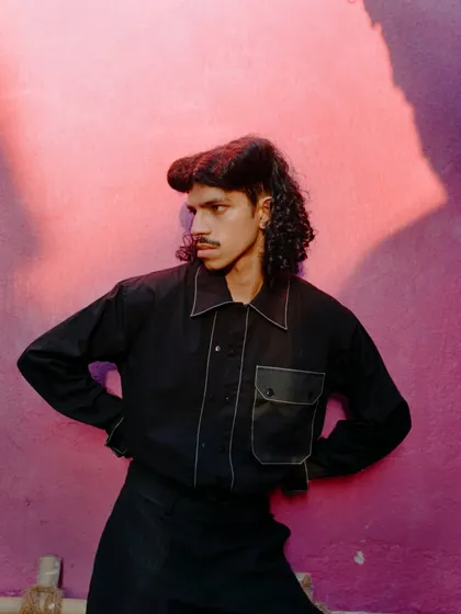 A play of light and shadow against the pink wall. This shot is more about mood and artistry, showing how I direct photographers to capture moments that go beyond a simple documentation of the clothes.