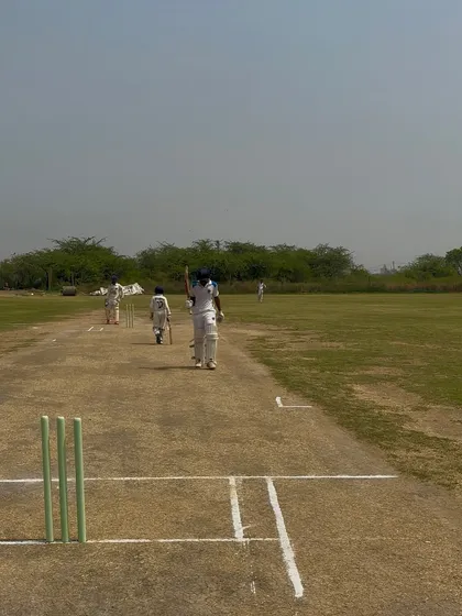 The batsmen walking back after setting a formidable total. Job half done.