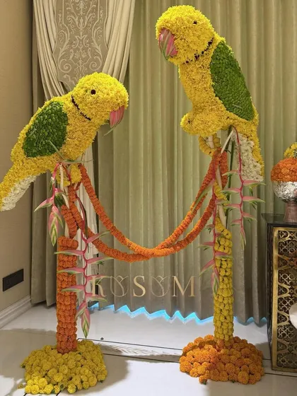 I love blending traditional Indian motifs with my own artistic style. These floral parrot sculptures, crafted from marigolds and chrysanthemums, were designed to bring an auspicious and artistic touch to a client's home entrance.