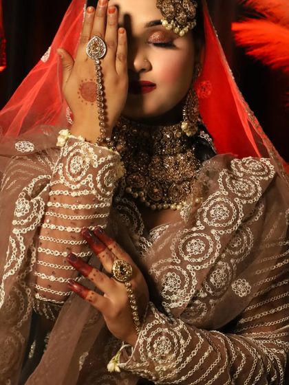 A dramatic shot of a Walima bride, with her face partially covered. This creates a sense of mystery and elegance.