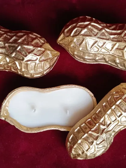 The peanut urli candle, shown with its lid slightly ajar.