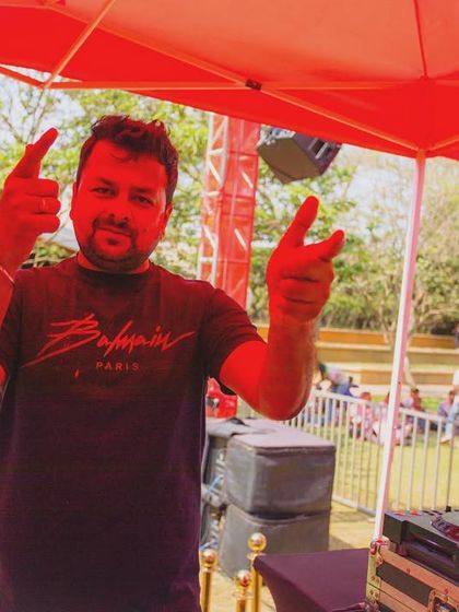 An artist hyping the crowd at our 'Colour Splash' event, showcasing the high energy and interactive nature of our parties.