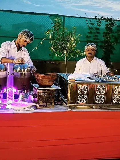A vibrant live chaat counter set up for an evening event. Under the twinkling lights, my team serves up delightful and spicy chaat, adding a touch of street food elegance to your party.