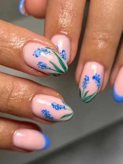 A beautiful hand-painted design of blue lavender or hyacinth flowers. Paired with a blue French tip, this manicure is elegant and artistic.