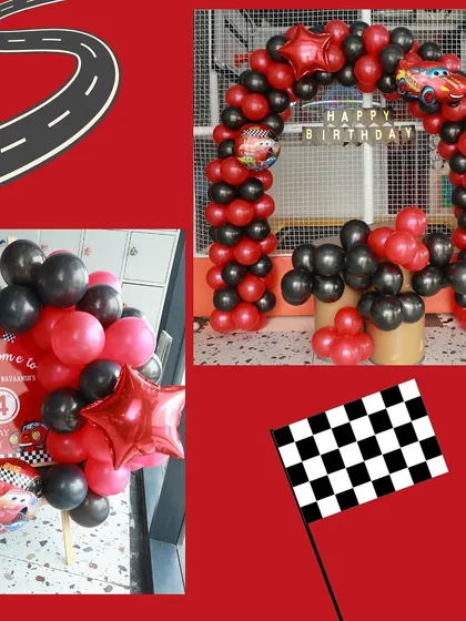 Our car-themed party decor in full swing. We use checkered flags, road signs, and character balloons to create a high-speed racing atmosphere.