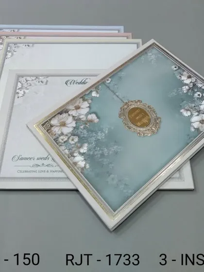 This invitation set features a framed floral design and comes with multiple inserts in coordinating colors. The look is soft, romantic, and elegant.
