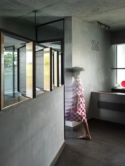 This artistic, motion-blurred shot captures the movement through our studio space. The design is intended to be a neutral canvas for creative thought, with raw concrete walls punctuated by carefully placed architectural details and moments of color.