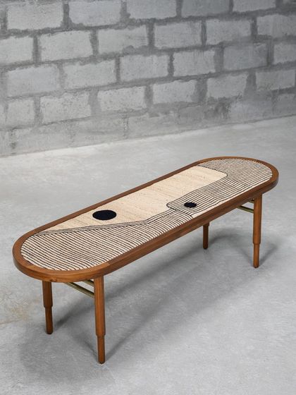 The Ela Accent Table is where modern aesthetics meet traditional craft. The tabletop, made of embroidered banana fiber, features a powerful 'Bindu' design, while brass rods provide support and a touch of elegance.