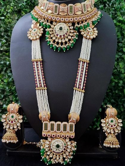 This grand bridal set features beautiful white and green kundan work with multi-layered pearl strands, offering a regal and sophisticated look for the main ceremony.