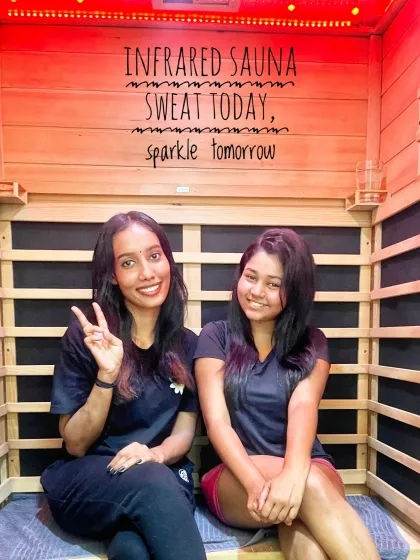 Sweat today, sparkle tomorrow. Here you can see two clients enjoying the gentle warmth of our private infrared sauna cabin. The experience is designed to boost circulation and detoxify your skin from the inside out, leaving you with a healthy glow.