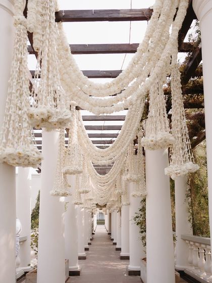 A beautiful walkway draped in garlands of fragrant tuberoses, creating a sensory experience for guests as they move through the venue.