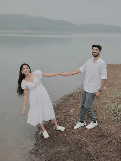 A playful, leaning pose on the edge of the lake, showing their fun-loving connection.