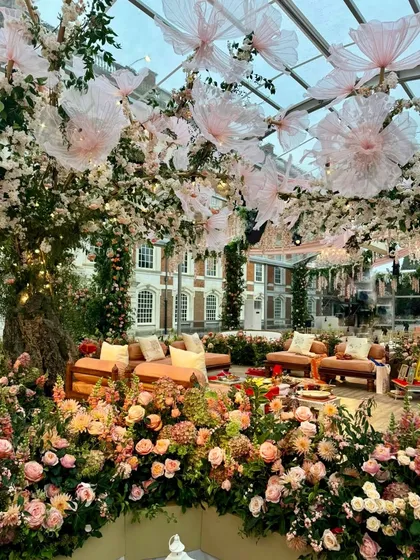 The interior of the Mehendi tent, showing a lounge area under a magnificent tree decorated with artificial cherry blossoms.