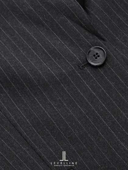 A close-up of the 130's count wool pinstripe fabric. The fine texture and subtle stripe create a look of understated luxury, ideal for high-quality business suits.