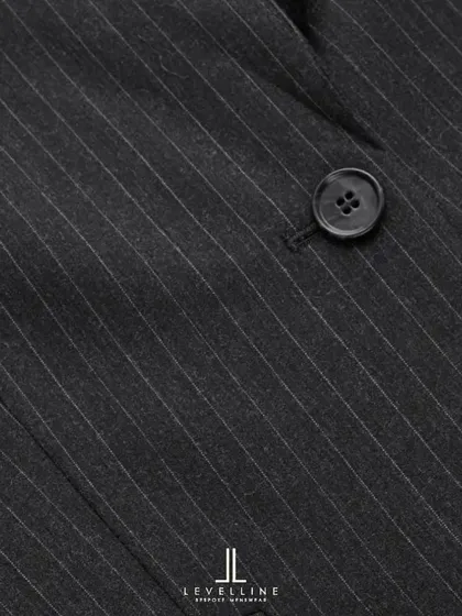 A close-up of the 130's count wool pinstripe fabric. The fine texture and subtle stripe create a look of understated luxury, ideal for high-quality business suits.