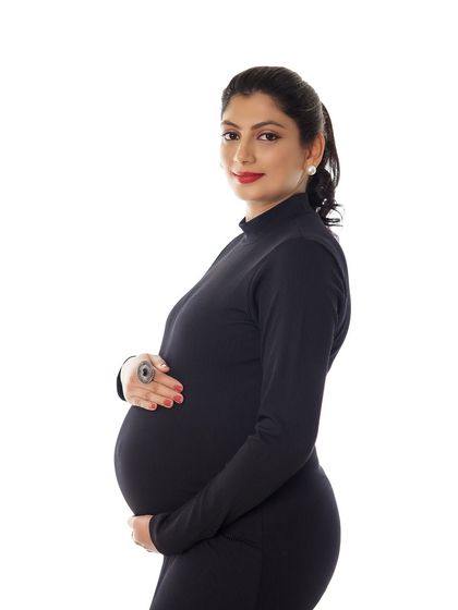A confident and classic portrait in a simple black dress. The pop of red lipstick adds a touch of glamour to this minimalist look.