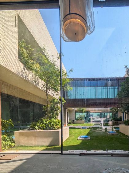 A preview of our Dubai Hills villa, 'Wahatan' (Oasis). The sand-toned brick walls and green courtyard create a cool, private sanctuary in the desert climate.