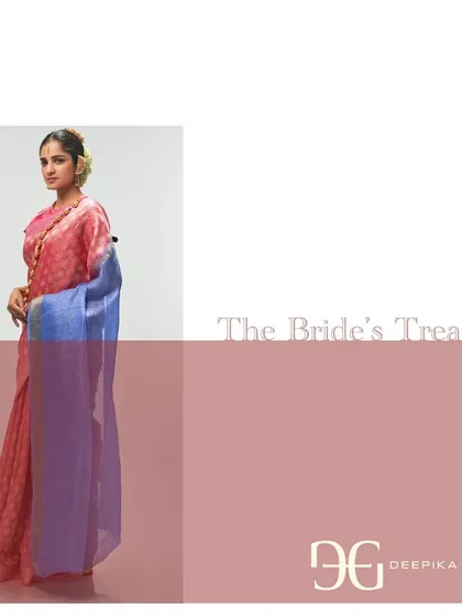 The elegant fall of the absolute coral tissue saree is highlighted in this shot. It shows how the modern design and surprising color combination come together to create a truly special garment.