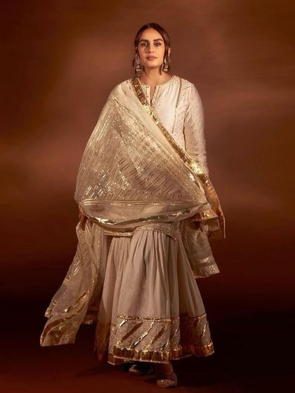 Another view of the ivory and gold sharara set, showcasing the shimmering dupatta.