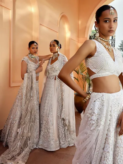 Another perspective of the coordinated white bridal looks. The focus here is on the different necklines and silhouettes, showing the variety available within a single color palette.