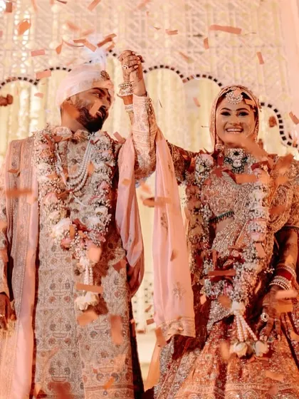 That moment of pure joy after the varmala exchange. We ensure the celebration continues with elements like a confetti shower to capture the happiness.