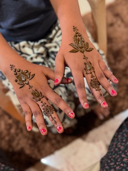 A very simple and delicate design for a guest. This pattern features a single lotus trail on the back of the hand, perfect for someone who wants just a touch of henna.