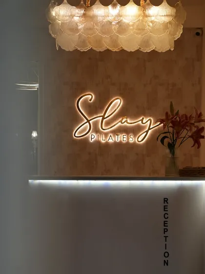 The first thing you see when you walk in. The Slay Pilates sign is a reminder that you're here to conquer your goals.