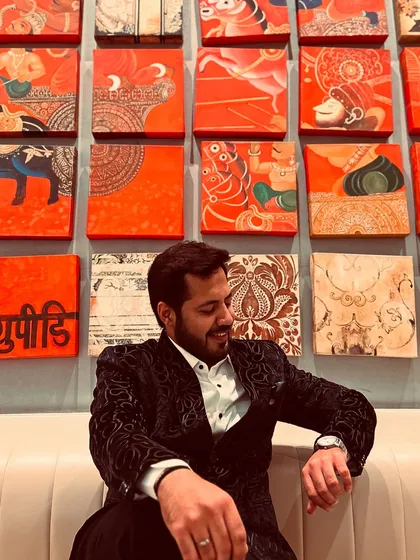 A candid, relaxed moment against a wall of traditional Indian art. I find inspiration everywhere.