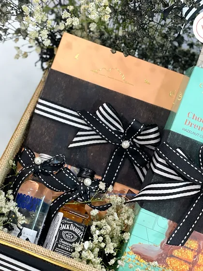This groom's hamper includes premium chocolates and miniature bottles of Jack Daniel's and Absolut, making it a perfect indulgence before the big day.