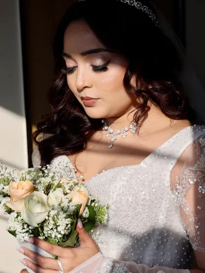 The magic of a sun-kissed Catholic bride. For Shirley, we created a full glam look with soft rose-gold hues on her eyes and a bold smoked-out wing. Paired with Hollywood waves, this look was all about accentuating her beautiful features for her walk down the aisle.