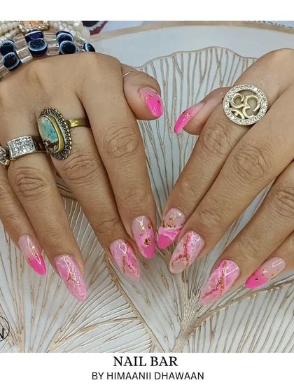 A beautiful pink marble design with gold foil flakes embedded within the nail for an extra touch of luxury.