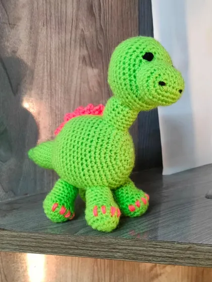 A cute green dinosaur I customized for an order. I can make dinosaurs and other animals in any color you like.
