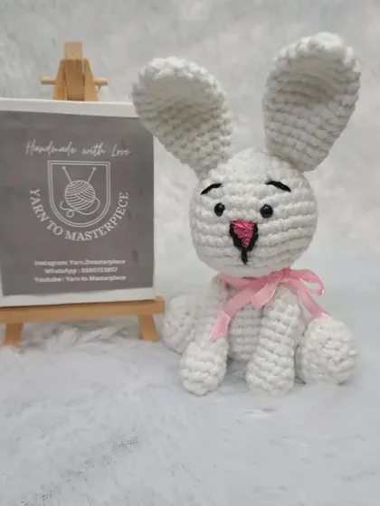 A clear shot of the small white bunny toy, showing its sweet, simple design and the quality of the crochet work.