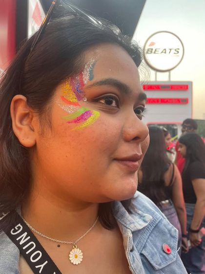 A vibrant, multi-color abstract glitter design. This look uses rainbow colors for a fun and expressive piece of face art.