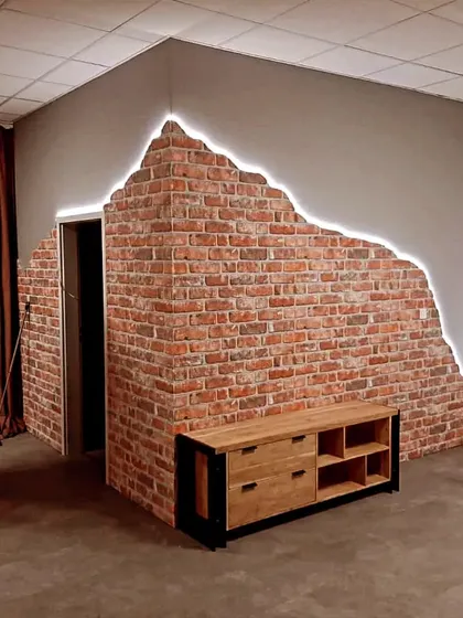 I can create unique accent walls that blend rustic and modern styles. This design features an exposed brick finish with a "broken plaster" effect, highlighted by a clean LED strip light that adds depth and drama.