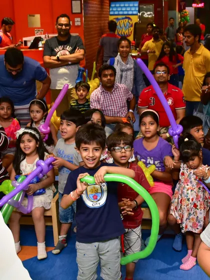 A big group of happy kids enjoying the party with balloon swords and hats. Our team organizes games and activities to keep everyone entertained.