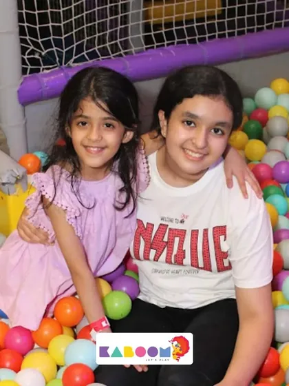Sisterly love in the ball pit! It's a great spot for making memories with family.