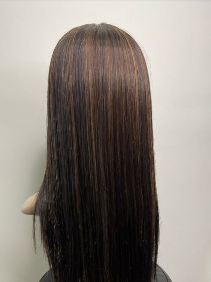 The back view of a highlighted silk wig, showcasing the expert blending of colors and the healthy, smooth texture of the real human hair.