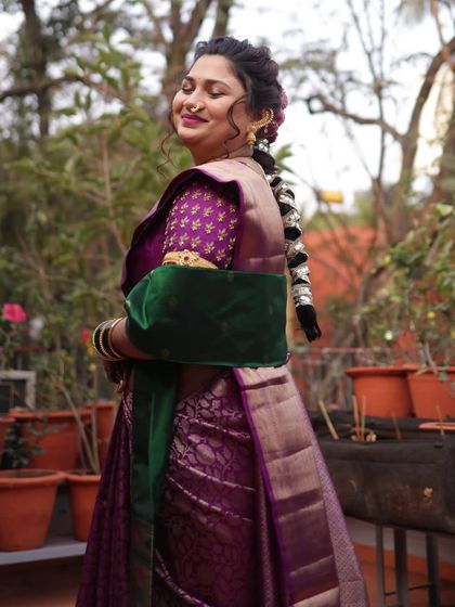 A serene portrait of the bride, showing the elegant fall of her saree and the traditional accessories that complete her wedding day ensemble.