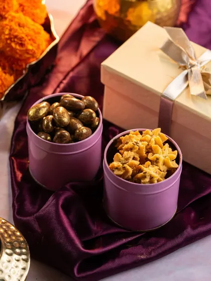 Our Diwali collection includes smaller treats too, like these tins of chocolate-coated nuts and savory bites, perfect for corporate or bulk orders.