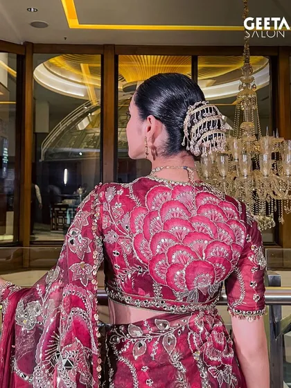A detailed shot of the intricate hair accessory and the clean lines of the bun, a perfect example of traditional elegance.